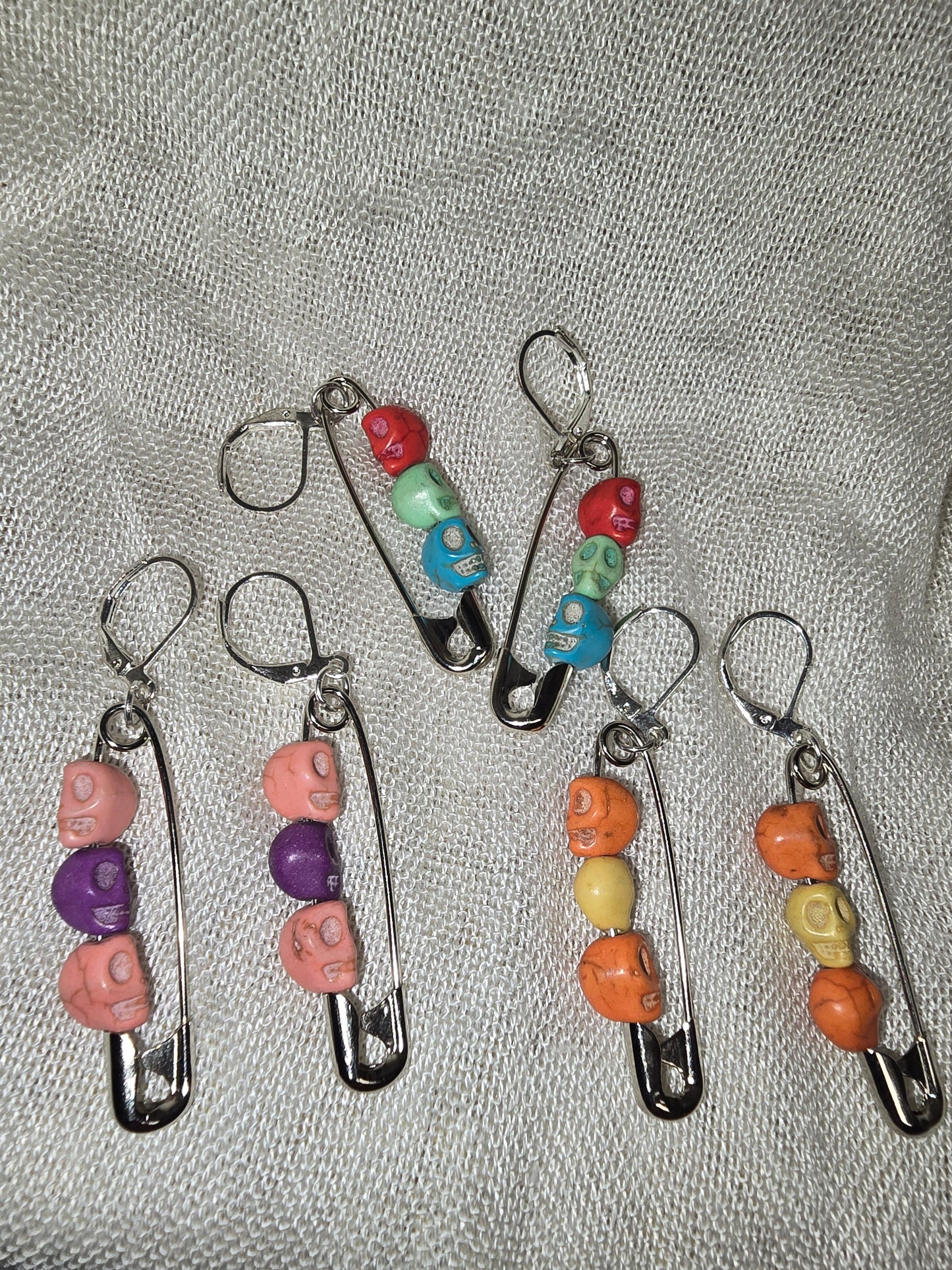 Safety pinned skull earrings